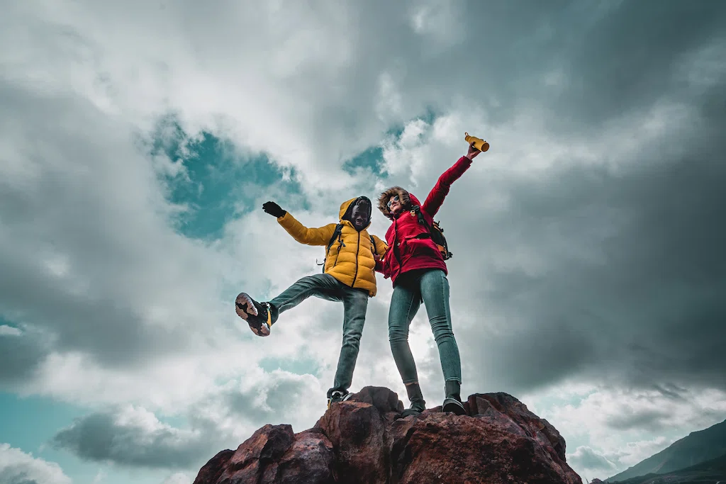 Hikers excited on mountain peak